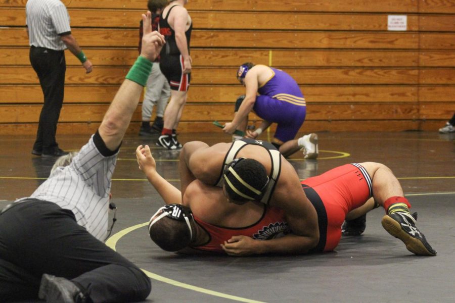 a member of the FHN wrestling team pins down his opponent