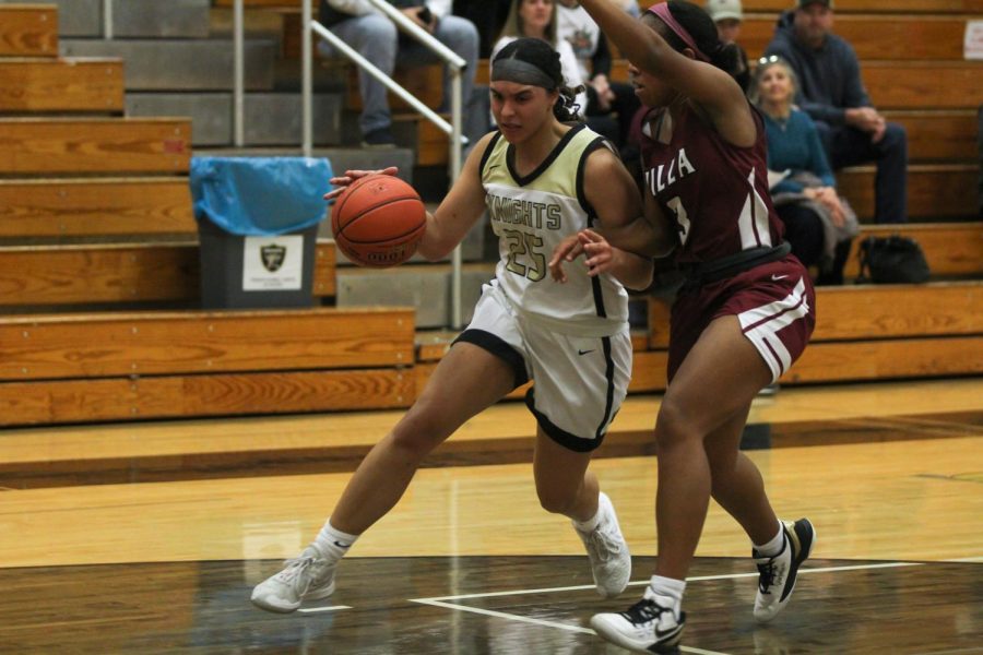 A member of the FHN girls basketball team dribbles against her opponent