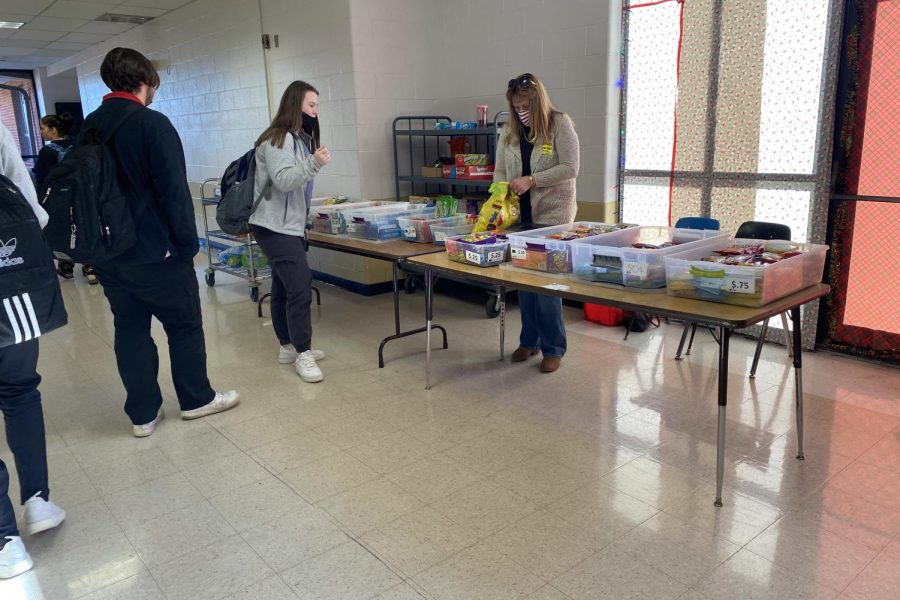 Senior Cat Connolly talks to the person who was working the snack table on Dec. 6. 