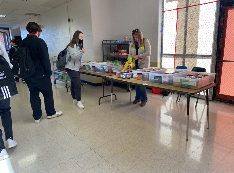 Senior Cat Connolly talks to the person who was running the snack table on Dec. 6.