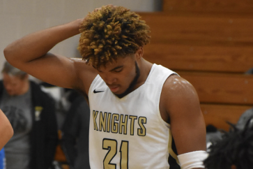 Senior and Varsity boys basketball player Trenton Oglesby regroups mid game vs SCW. 