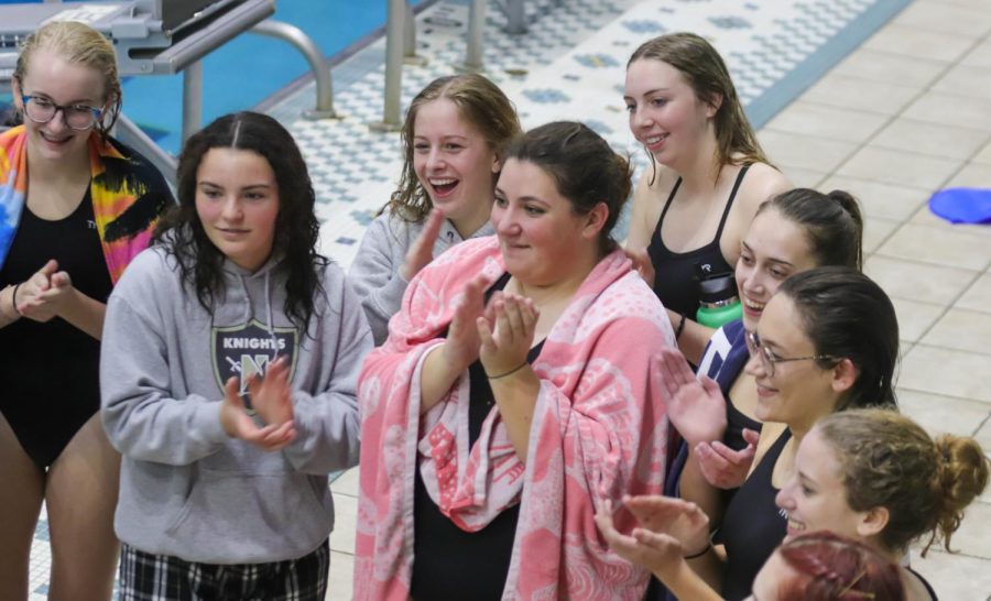 Morgan Statzer celebrates after a successful meet with teammates Hayden Puhr and Sailor Sulin. 