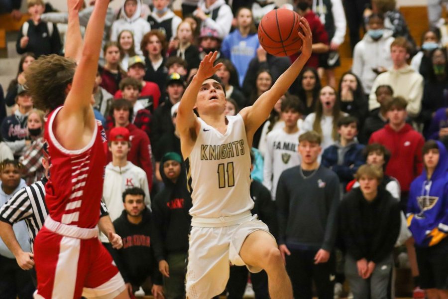 FHN player 11 shoots the basketball during a game.