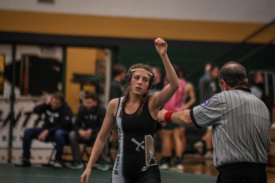 Freshman Isabelle Apple raises her arm after winning a match on Feb. 1.