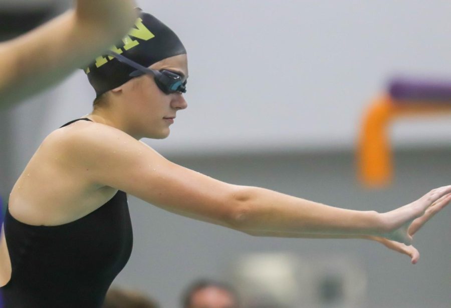 Senior Rylie Miller prepares to dive into the water at the start of her race on Dec. 6.