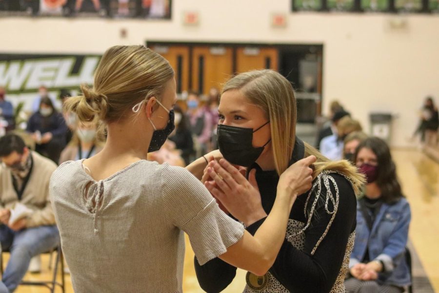 Kristen Johnson places the Knights of the Roundtable medal upon the shoulders of one of the recipients