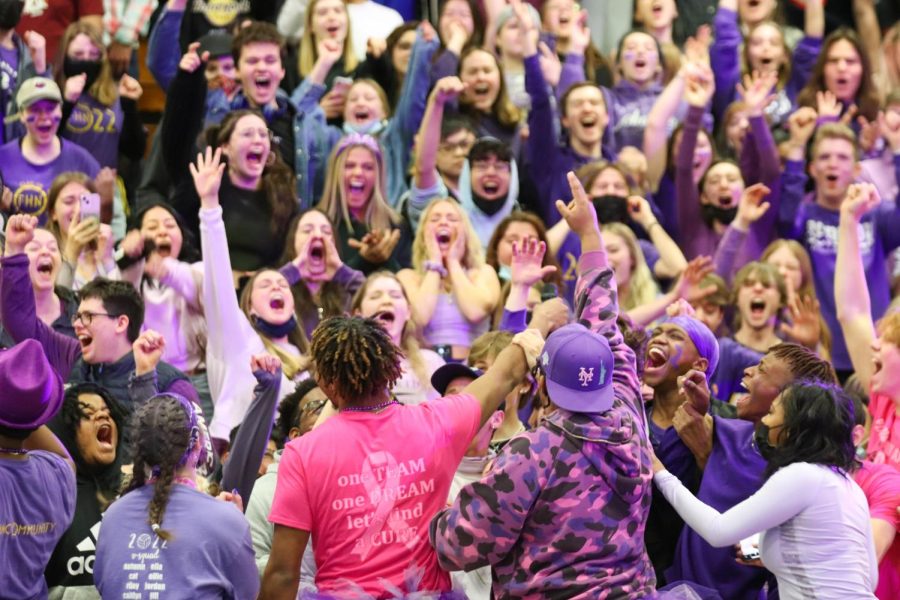 Emcees Trenton Oglesby, Logan Currie, Cat Connolly, and Chas Hoskins hold the microphone towards the senior class during a pep assembly. The crowd was playing a game called "finish the lyric". This Snowcoming pep assembly was the senior class of 2022's last pep assembly before graduation. The seniors all wore purple, their class color, for the assembly. 