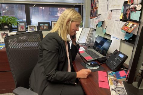 Shelly Parks sits at her new desk in the main office.