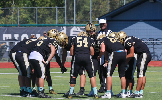 The Francis Howell North football team huddle together during a game. 