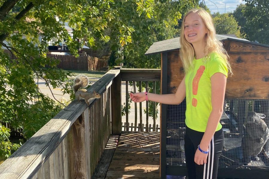 Sophomore Faith Fuller holds food out for one of her squirrels.