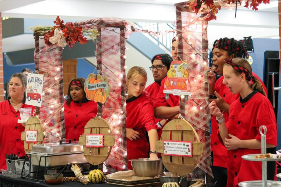 Chefs Audrey Wright, Xavier Mitchell, Janiah Like, Austin Bitter, Anthony Guerrero, table setter Sydney Gronemeier, dishwasher Cassie Hodgkins and culinary teacher Rebecca Just group together as they wait for the winner of the competition to be announced. 