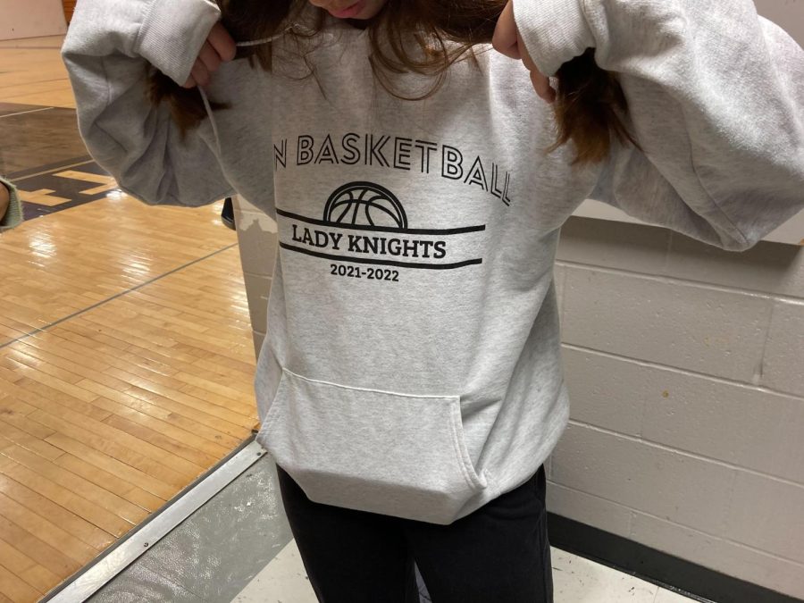 A player on the girl's basketball team wears a hoodie that says "Lady Knights"