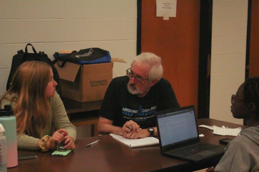 Speech and debate coach Randy Pierce helps debaters on their cases. Pierce has speech and debate meetings every Tuesday and Thursday where they meet and discuss their arguments. 