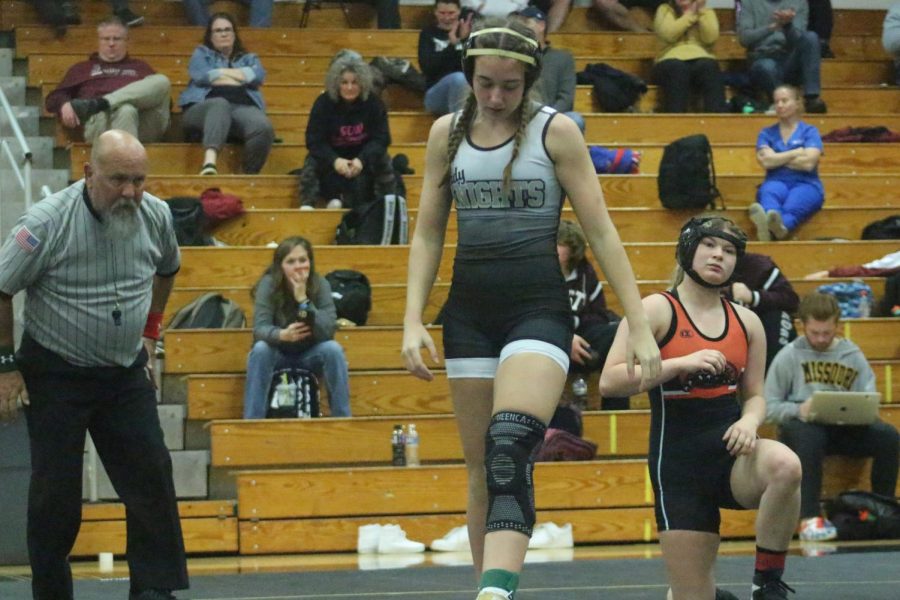 Freshman Aubrey Peterson walks off the wrestling mat after beating an opponent. 