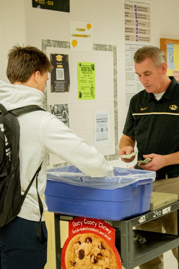 Michael Freedline, DECA club sponsor, sells cookies outside room 22 on Jan 4. 