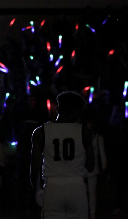 Senior Kalabe Nebyu walks onto the court after his name was called during the senior appreciation ceremony before the game.