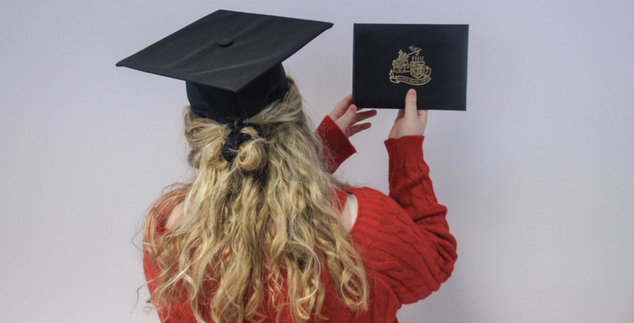 Senior Rachel
Trapf holds a
diploma while
wearing a graduation
cap on Nov.
17. The seniors
last day of school
is expected to be
May 18, but can
change with possible
snow make
up days. However,
graduation will still
take place on June
3.