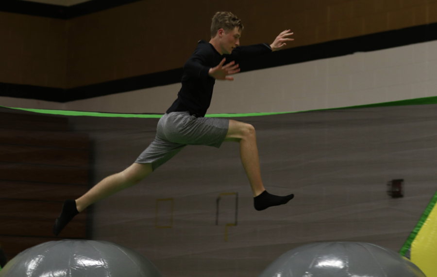 Senior Henry Willie Jumps on inflatables during the KOE Picnic in 2022