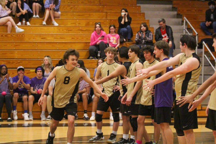 Boys volleyball players high five on senior night. The boys volleyball team played against Fort Zumwalt West on April 26, 2022. The boys won all three sets taking the win over FZW.