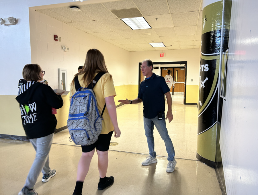 Bob Brown stops students from leaving at the lunch room exit. 