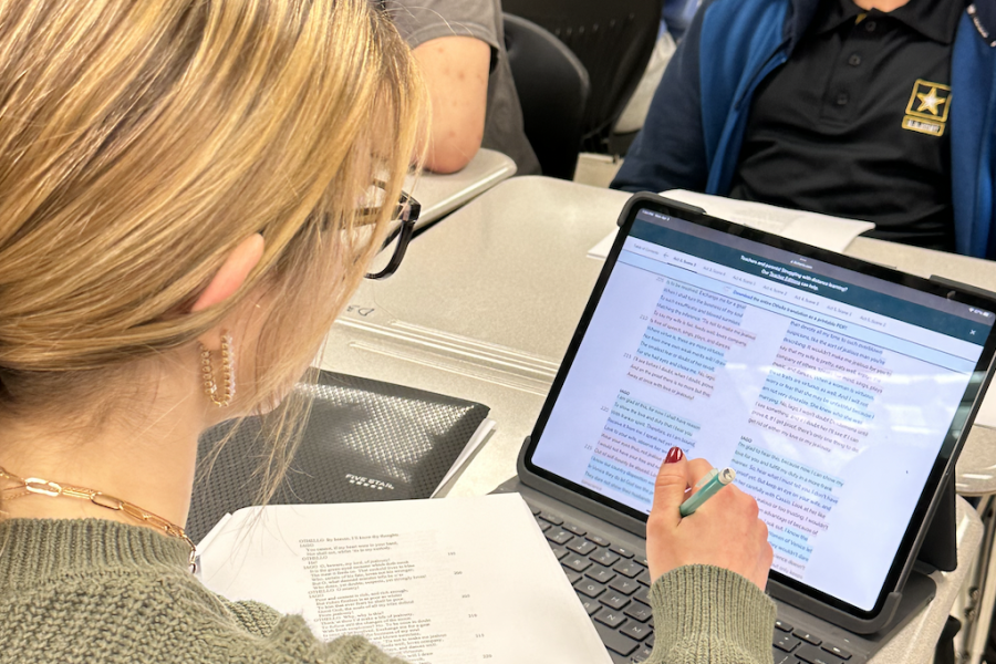 Senior Chloe Perkins follows along with the reading of Shakespeare’s “Othello” in the 7 period AP Literature blended class. Teacher Amy Stoker reads out the major part, Iago, to keep the flow of the reading for the class.