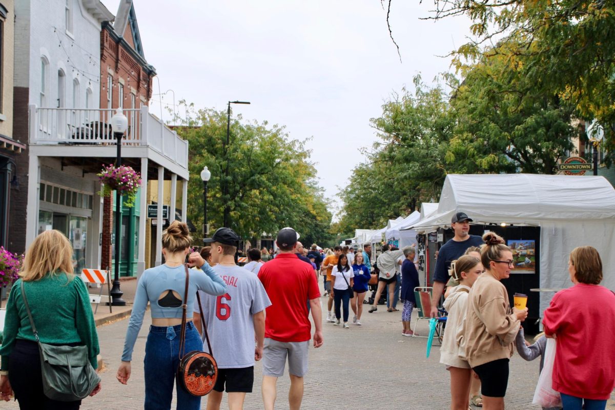 People walk at the Riverwalk Market and look at various vendors. 