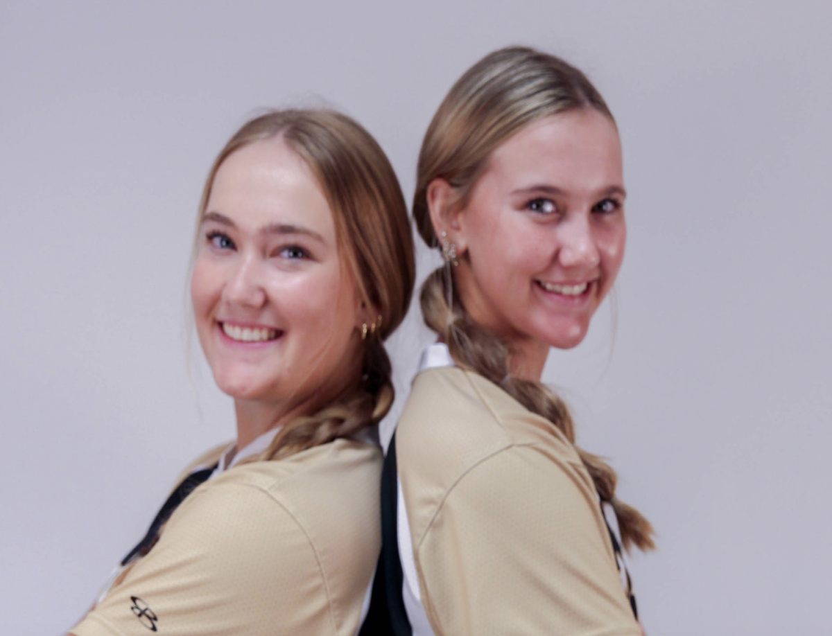 Freshman Lexi Lohnes and senior Kaylee Lohnes pose for a picture in their FHN softball gear. They are both on the FHN varsity softball team this year as Lexi stars as a pitcher and right fielder and Kaylee stars as a center fielder and right fielder. They also have played in another team out of school called the Missouri Bombers, and have both played softball since a very young age.