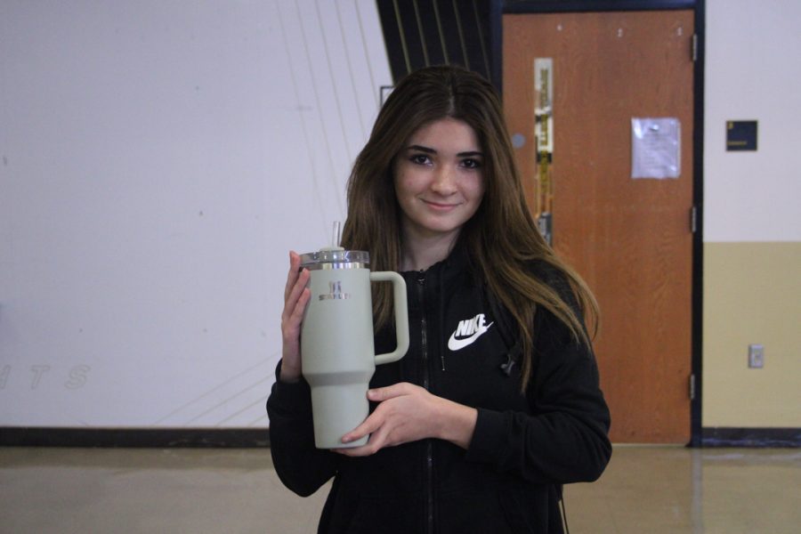 Junior Ashley Mora poses with a Stanley cup.