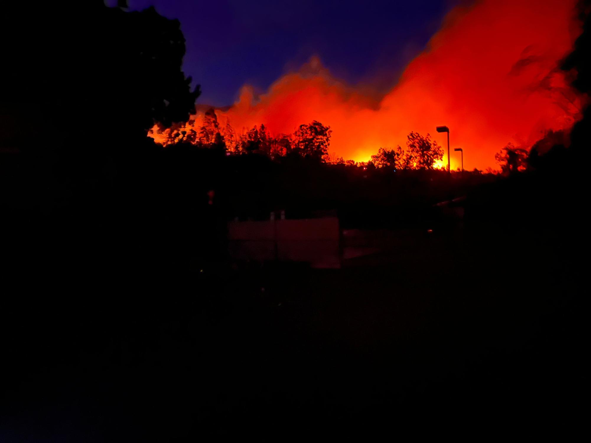 A wildfire rages on in the distance in Lahaina, Hawaii.