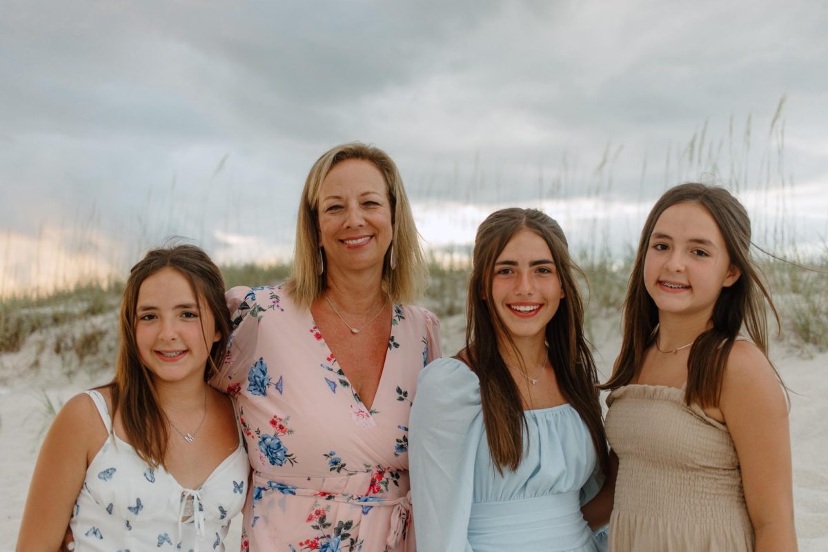 Ally, Madi and Maggie stand together with their mother Donna after 10 years of living together.