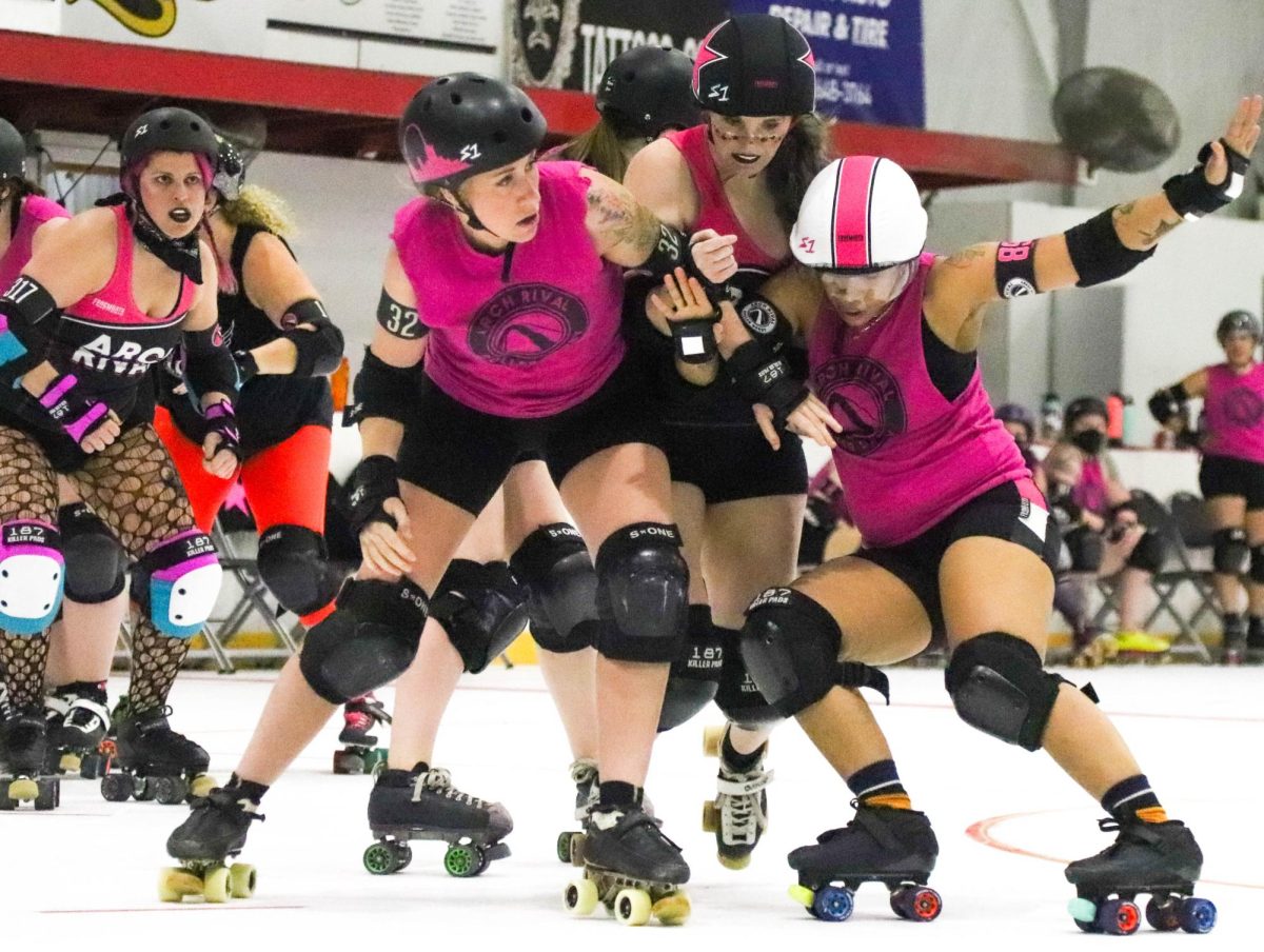 Two players block the path of the jammer on the track on Feb. 17 during a scrimmage between the pink and black teams. While most of the players are blockers and have nothing on their helmets, there are special caps for pivots and jammers. Jammers score points and mount a star on their helmet while pivots host a stripe, which they trade for the star if their jammer is unable to make it through the large group of blockers, also known as 'the pack'.

"I've had a number of friends I talked to about it that say, frankly, they don't think they have the almost aggressiveness for it," first-year skater Rabia Polzin said. "But I think sometimes that's almost a misnomer, a misunderstanding. They feel like there's a lot of people who don't feel they have the aggressiveness for it. But I think one, you'll surprise yourself. And two, you don't need to be a super aggressive person to do derby."
