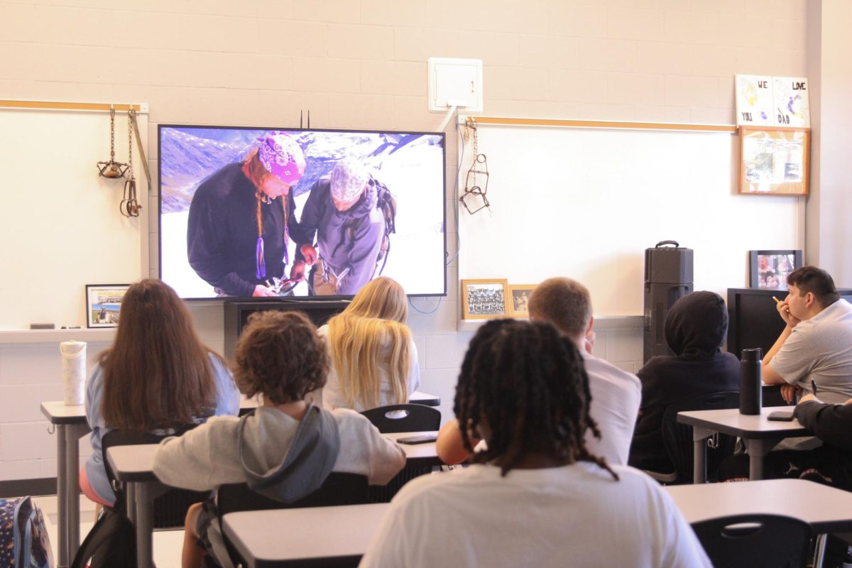 John Brune shows students in his 7th hour hunting and fishing class a video on survival as they take notes on Oct 4.