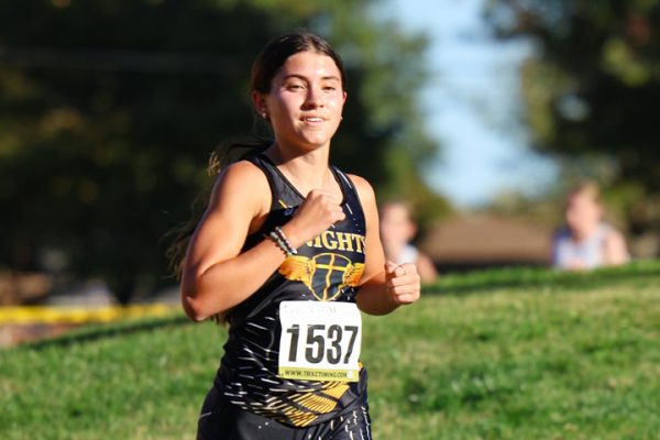 Senior Madeline Dustin runs in a meet for cross country. 