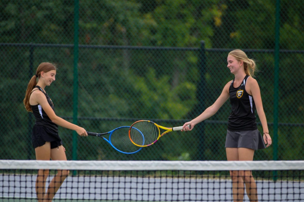 Junior Kailyn Curtis and Freshman Sophie Kraemer celebrate scoring a point against. Curtis and Kreamer play against Fort Zumwalt West and won 9-0. 