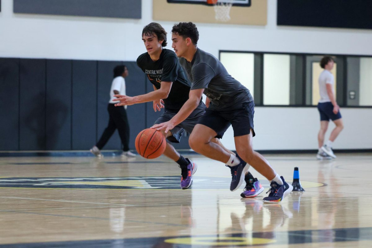 Senior Champ Pauley with David Beger dribbles during basketball practice. This year, the coaches are putting an emphasis on full court pressure, fast-paced offence, defense and overall being the fastest and strongest. Practices involve many drills such as running drills. This goes along with the coaches wanting to condition the players well and overall be more disciplined this year. 