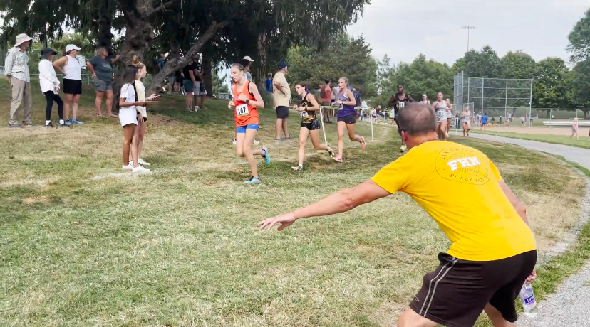 Coach Joe Brocksmith directs and coaches runners Sept. 19 during a Lutheran North Invitational.