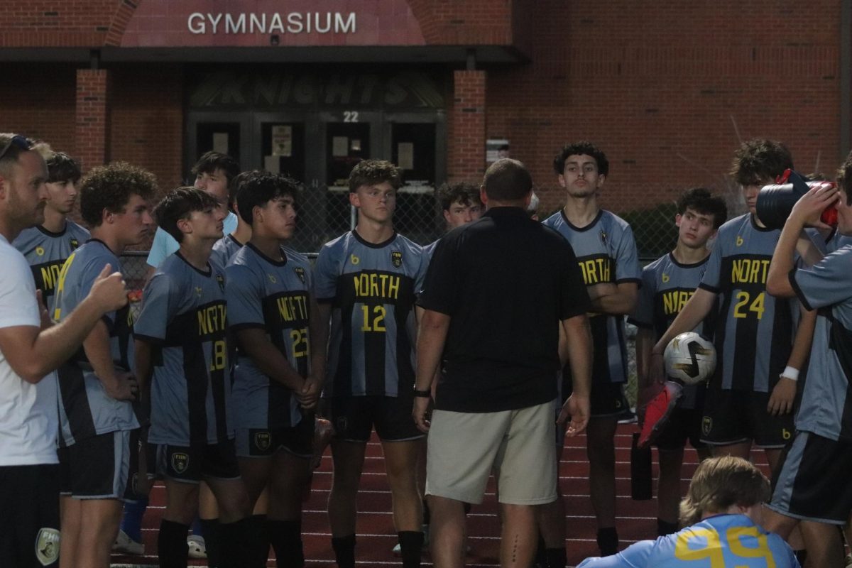 Head coach Travis Cairer huddles boys
varsity soccer together after a 0-5 defeat
against Liberty on FHN home turf.