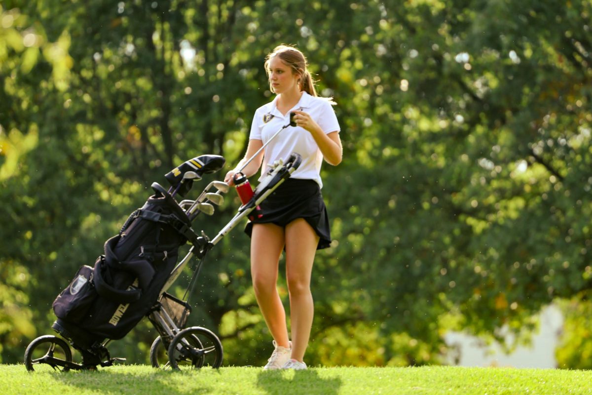 Senior Rachel Bruemmer puts her putter into her golf bag after hole five at Links at Dardenne on Sept. 19. The Knights won their first match of the year 199 - 217. 