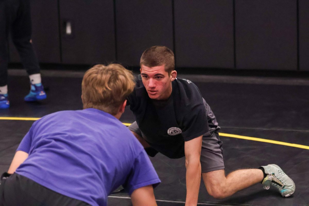 Collin Conley bends down to fight another wrestler during wrestling tryouts. 