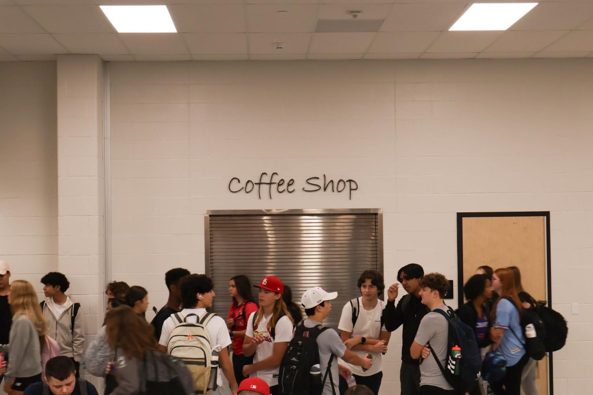 Students gather around the closed Coffee Shop before school. The Coffee Shop has yet to open, but administration has plans for the future. 