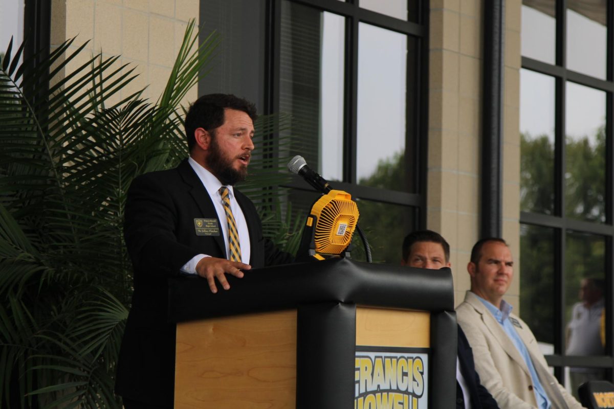 Building Principal Jeffrey Fletcher speaks at the ribbon cutting ceremony during the annual Black and Gold day event. 