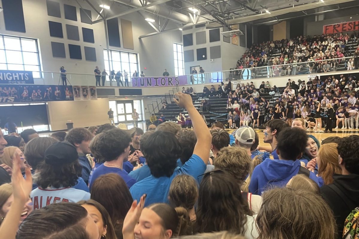 Seniors gather in a crowd to show class spirit at the Snowcoming pep assembly