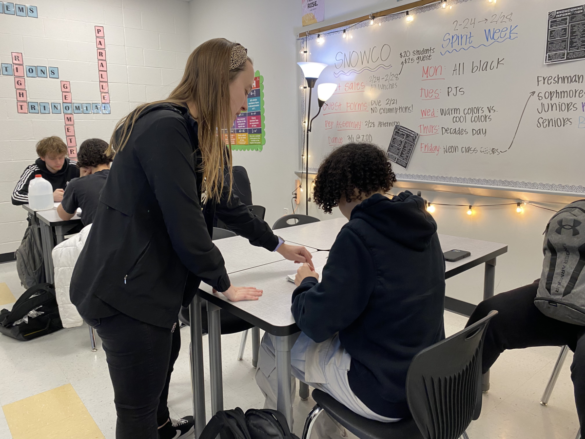 Emilee Fischer helps sophomore Walter
Walker through a review packet in a
math class.