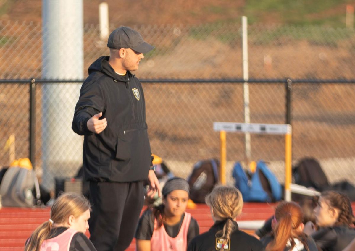 Matt Havermale talks to varsity girls soccer during practice.