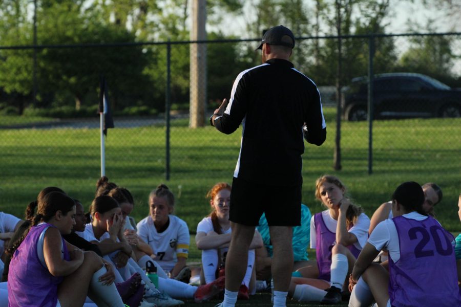 Head soccer coach Matt Havermale huddles the varsity soccer team during half time on April 21.