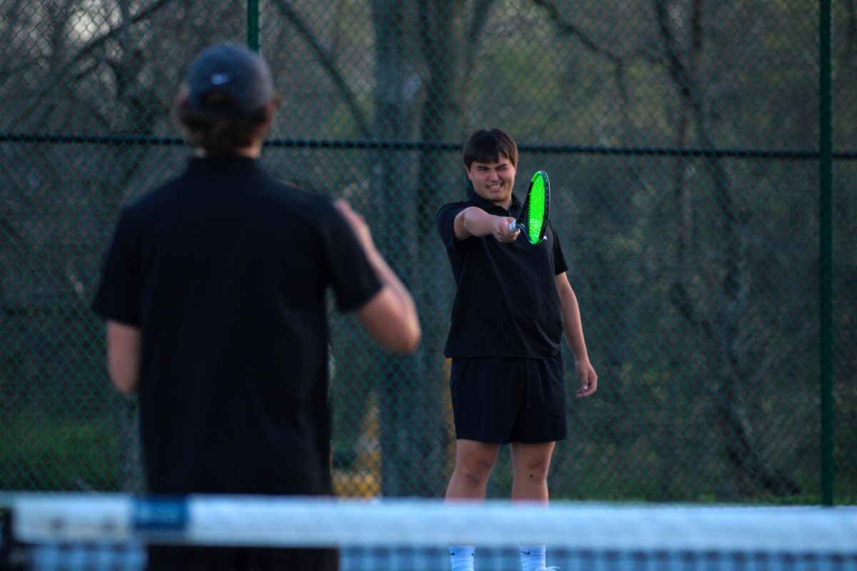 Kai Gustafson celebrates after hitting a ball against a teammate during an extra practice on April 13.