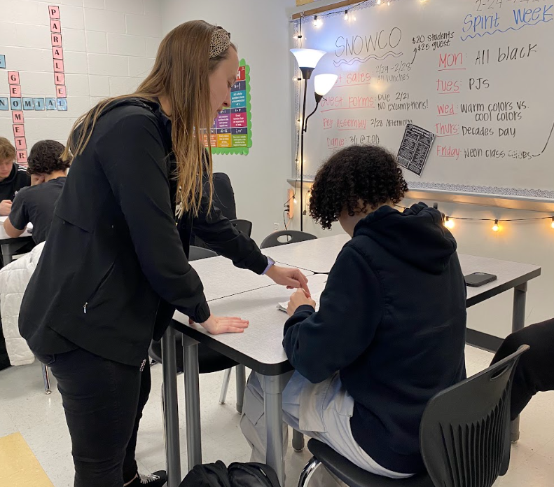 Emilee Fischer helps sophomore Walter
Walker through a review packet in a
math class