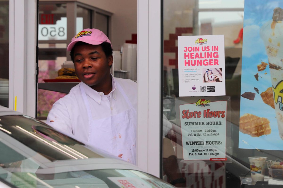 Andy’s worker serves custard through the drive-thru.