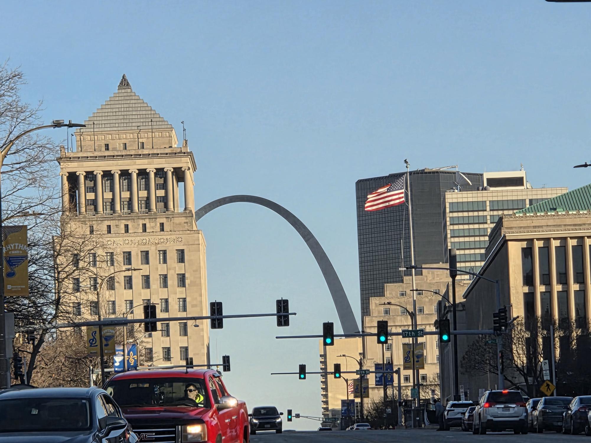 The Civil Courts Building located on 4th Street in downtown St. Louis, with a flag blowing towards the Arch. 