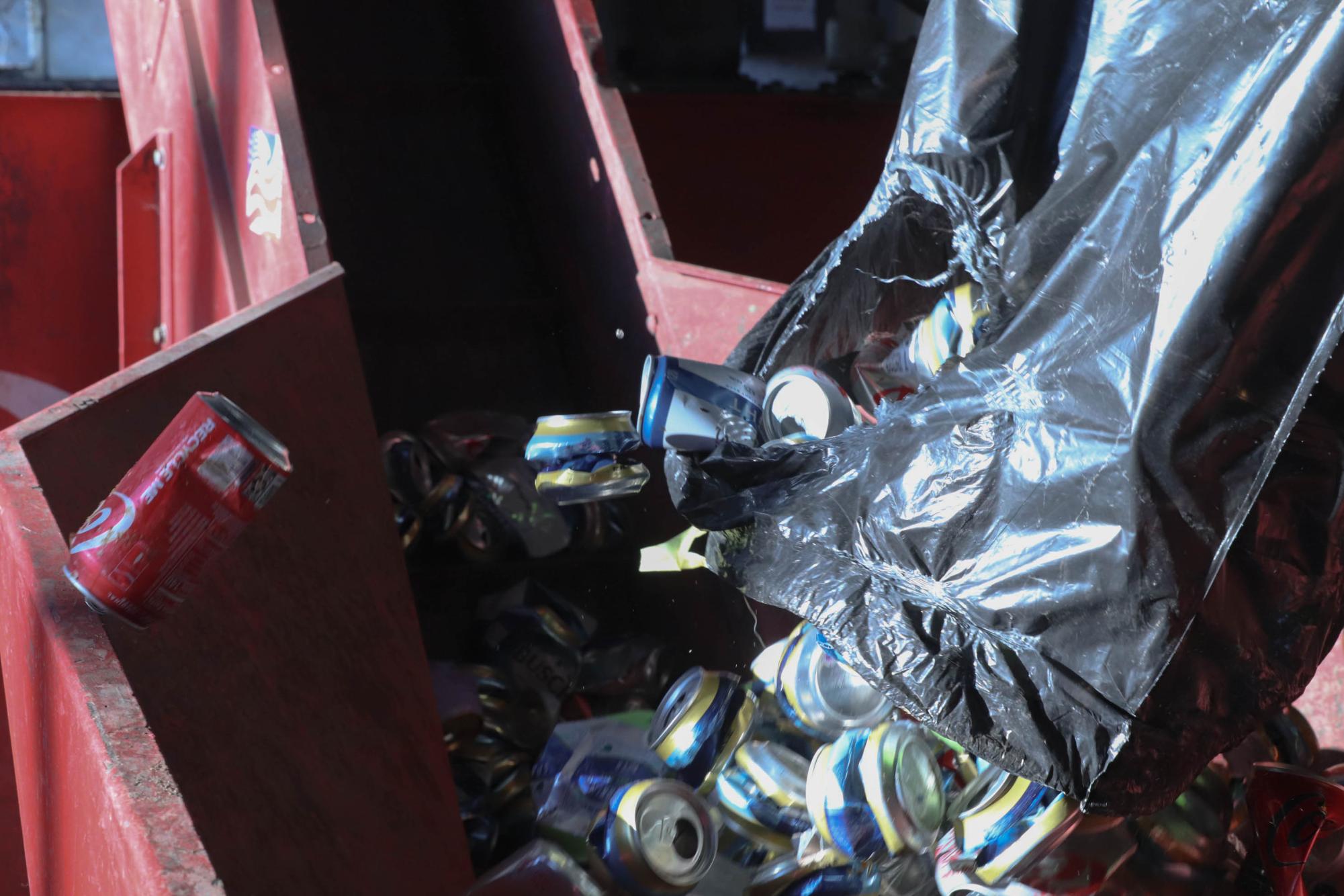 Items ready to begin the recycling journey are loaded into a metal baling machine at SA Recycling.